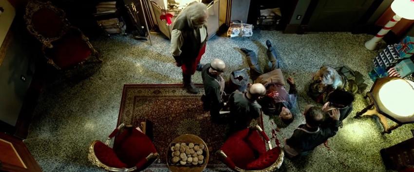 A Christmas Horror Story (1970) Movie scene: In an overhead shot, Santa Claus (George Buza) looks down at Jingles (Joe Silvaggio), who is bleeding on the floor
