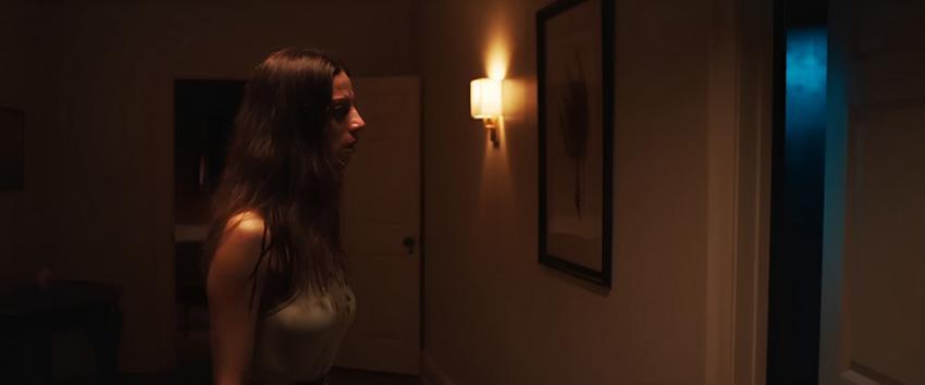 A House on the Bayou (1970) Movie scene: Sophie (Angela Sarafyan) standing outside the ominous door in the hallway, which is emitting a blue light