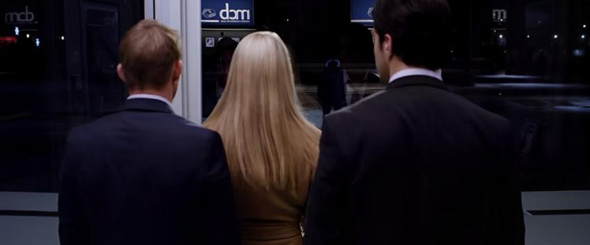 ATM (1970) Movie scene: A shot from behind with David (Brian Geraghty), Emily (Alice Eve), and Corey (Josh Peck) with their backs facing us, and the antagonist standing in view over their shoulder