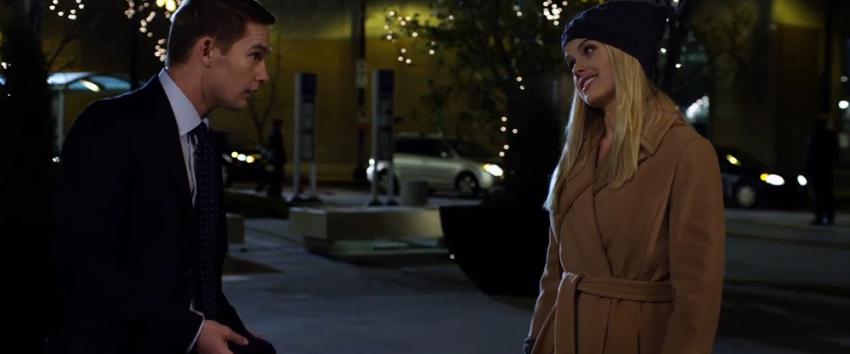 ATM (1970) Movie scene: David (Brian Geraghty) and Emily (Alice Eve) in conversation with Christmas lights in the background