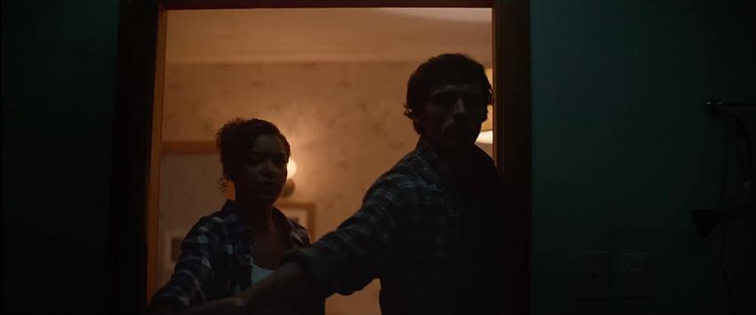 Bagman (1970) Movie scene: Karina (Antonia Thomas) and Patrick (Sam Claflin) stand at the entrance of a bedroom door