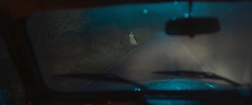 Black Cab (1970) Movie scene: A shot from inside the cab showing a woman standing on the side of the road