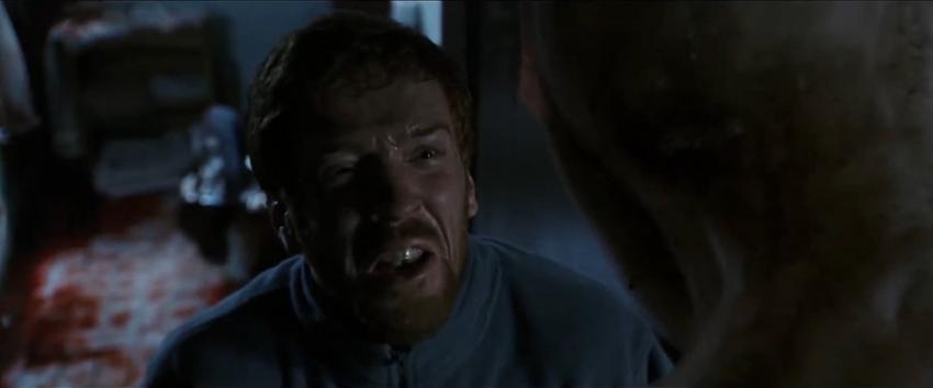 Dreamcatcher (1970) Movie scene: Jonesy (Damian Lewis) looking scared and distressed as he gazes up at Mr. Grey