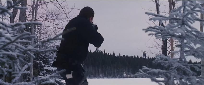 Dreamcatcher (1970) Movie scene: A man pointing an automatic rifle at a helicopter flying above