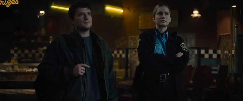 Five Nights at Freddy's (1970) Movie scene: Mike (Josh Hutcherson) and Vanessa (Elizabeth Lail) inside the dimly lit Freddy Fazbear arcade dining area