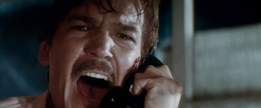 Halloween III - Season of The Witch (1970) Movie scene: Daniel (Tom Atkins) yells into the telephone with a look of despair.