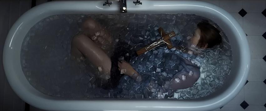Here After (1970) Movie scene: Claire (Connie Britton) submerged in the bathtub, holding a cross