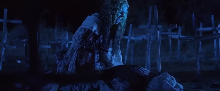 House of 1000 corpses (1970) Movie scene: Baby (Sherri Moon Zombie) covered in blood, holding a knife over a bloodied victim in a graveyard at night