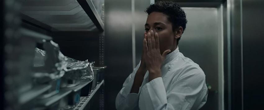 House of Spoils (1970) Movie scene: Chef (Ariana DeBose) clutching her face in shock as she surveys the kitchen chaos