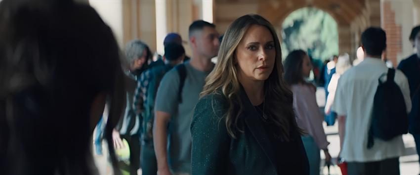 I Know What You Did Last Summer (1970) Movie scene: Julie James (Jennifer Love Hewitt) standing under the arches of a crowded pathway.