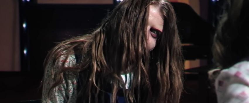 Late Night with The Devil (1970) Movie scene: Lilly (Ingrid Torelli), her hair covering her face, appearing unhinged