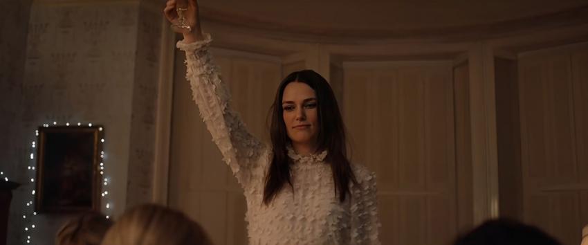 Silent Night (1970) Movie scene: Nell (Keira Knightley), in a white lace dress, raising her champagne glass.