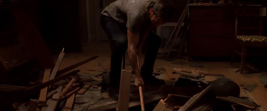 Stir of Echoes (1970) Movie scene: Tom (Kevin Bacon) smashes through a wooden floor with a sledgehammer.