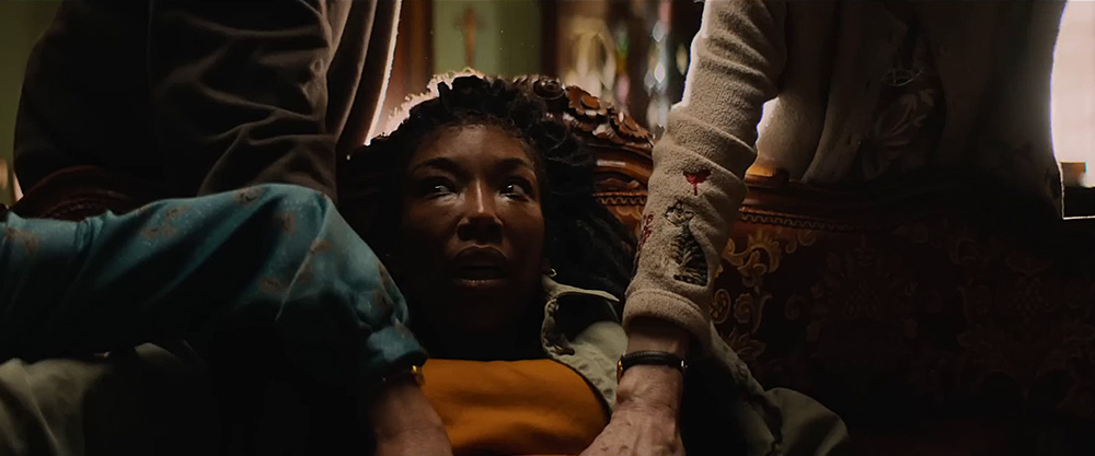 The Front Room (1970) Movie scene: Belinda (Brandy Norwood), with an expression of fright, sitting down and surrounded by three people