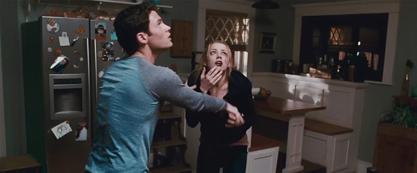 The Stepfather (1970) Movie scene: Michael (Penn Badgley) and Kelly (Amber Heard) look startled after hearing a noise.