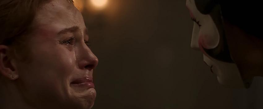 The Strangers: Chapter 1 (1970) Movie scene: A tearful and fearful Maya (Madelaine Petsch) locked in a tense stare-off with Pin-Up Girl