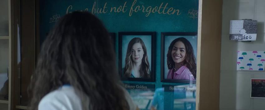 Time Cut (1970) Movie scene: Lucy (Madison Bailey) walks past a photo of her sister Summer (Antonia Gentry) in the school corridor