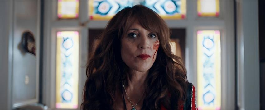 Torn Hearts (1970) Movie scene: Harper Dutch (Katey Sagal) with a focused stare and a blood smudge on her left cheek