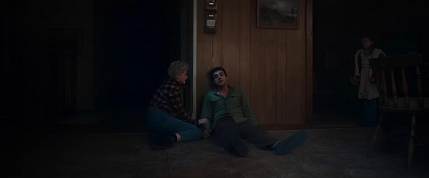 Wolf Man (1970) Movie scene: Charlotte (Julia Garner) kneels beside a wounded Blake (Christopher Abbott)